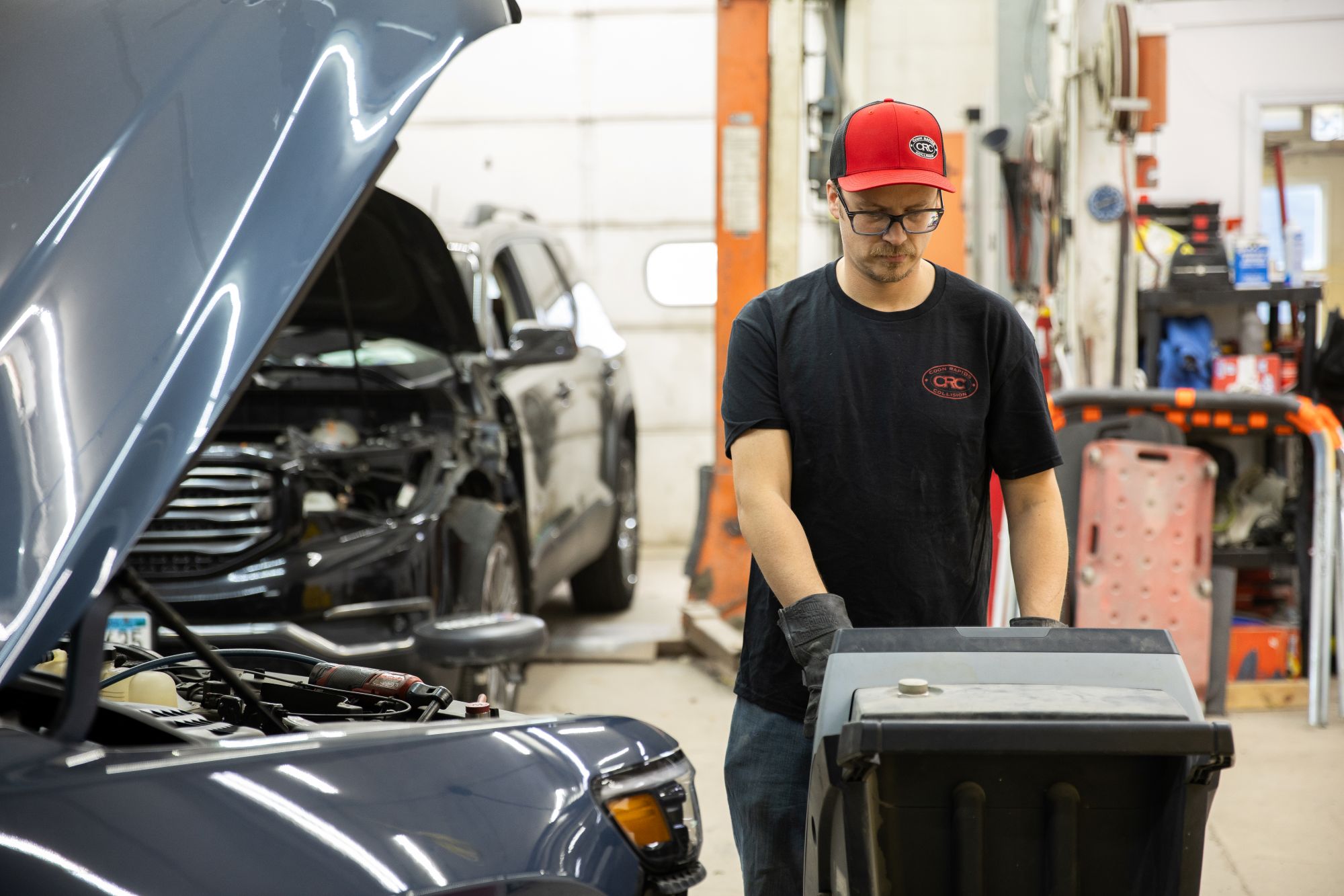 Owner Cole completing auto body repairs- Coon Rapids Collision - auto body repair equipment