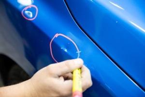 Paintless Dent Repair- marking dent areas - Coon Rapids Collision